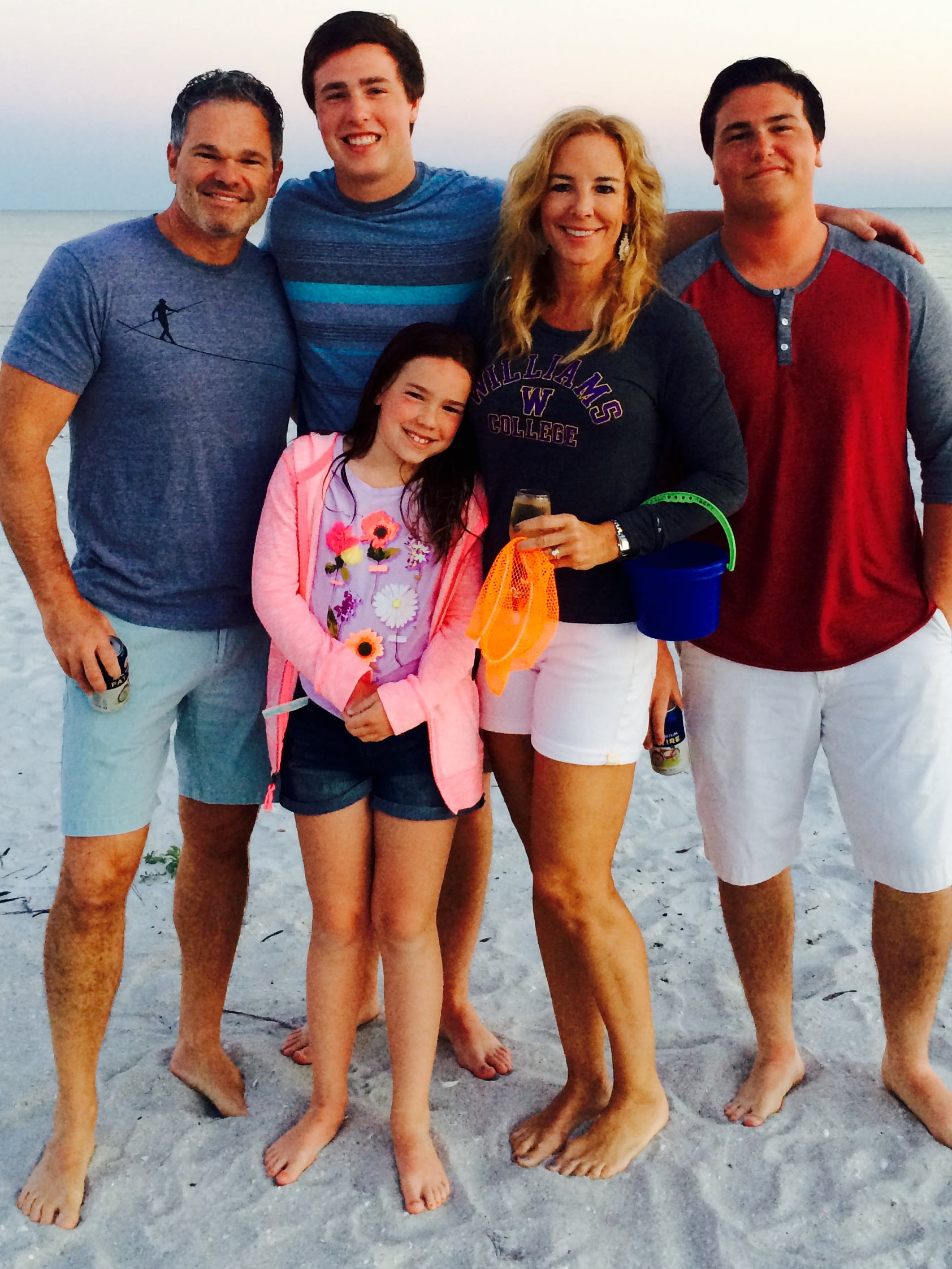 family poses at beach