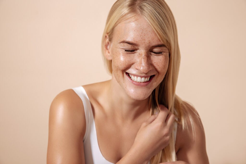 Smiling young woman with glowing, hydrated skin after Skinvive treatments